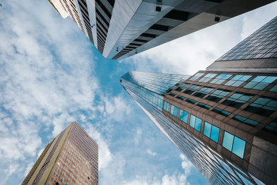 Low angle view of skyscrapers against blue sky