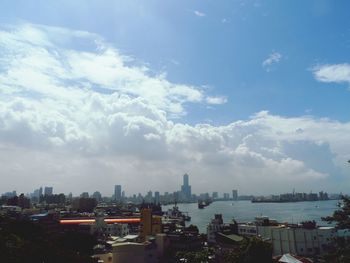 Cityscape against cloudy sky