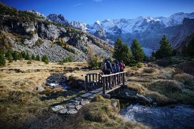 People on mountain against clear sky