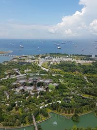 High angle view of cityscape by sea against sky