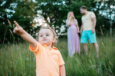 Baby boy standing on field