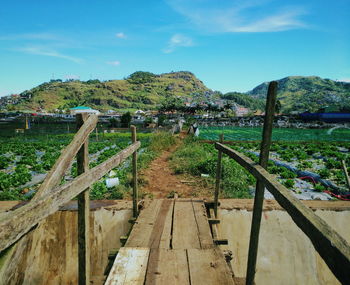 Scenic view of river by mountains against sky