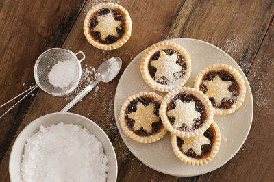 High angle view of star shape mince pie in plate on wooden table