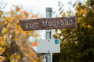 Information sign against trees