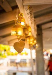 Low angle view of illuminated lanterns hanging in building