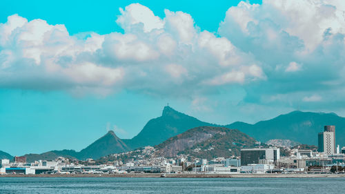 Panoramic shot of townscape by sea against sky