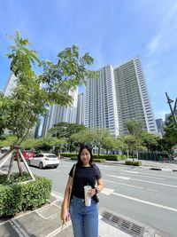 Low angle view of woman standing against sky