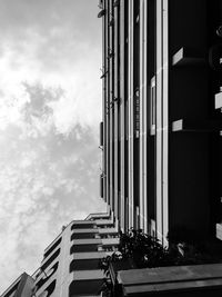 Low angle view of building against cloudy sky