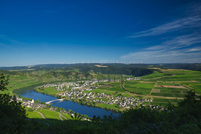 Scenic view of agricultural field against blue sky