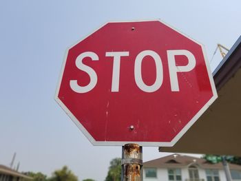 Low angle view of road sign against sky