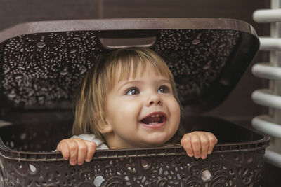 High angle view of cute boy sitting in car