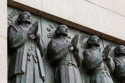 Low angle view of statues on wall