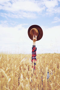 Woman standing in field against sky