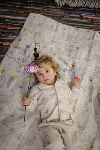 Portrait of cute girl lying on bed