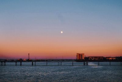 Scenic view of sea against clear sky at sunset