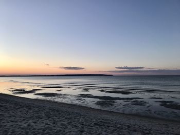 Scenic view of beach against sky during sunset