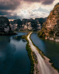 Scenic view of river amidst mountains against sky