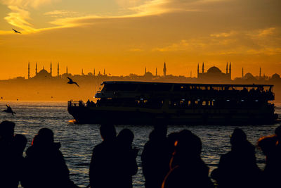 Istanbul silhouette of people on boat in sea during sunset