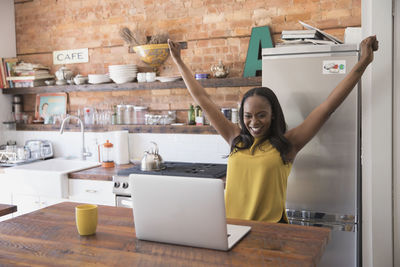 Businesswoman stretching while working at home