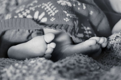 Close-up of baby feet on bed