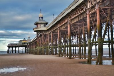 View of pier on beach against sky