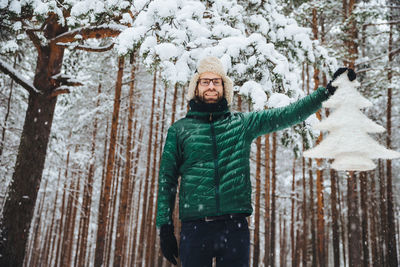 Portrait of man standing in snow