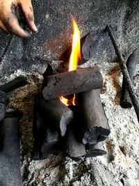 Close-up of hand holding burning leaf