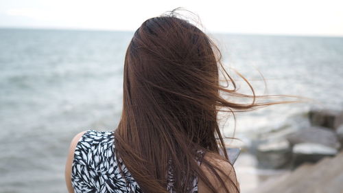 Rear view of woman looking at sea 