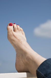 Low section of woman against sky