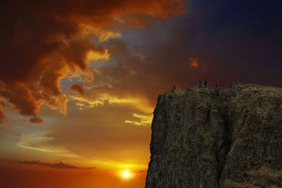 Low angle view of rocks against sky during sunset