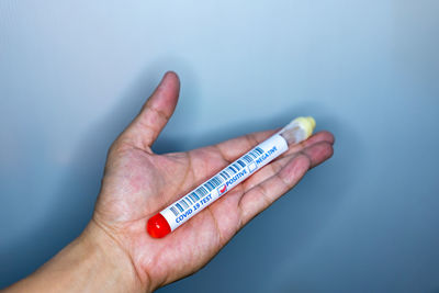 Close-up of hand holding blue ring