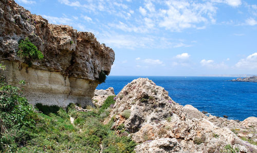 Rock formation on beach against sky - malta 