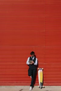 Full length of a man using mobile phone