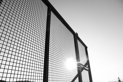 Low angle view of fence against clear sky