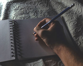 Close-up of hand holding book