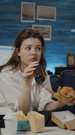 Portrait of a young woman sitting on table