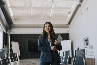 Smiling businesswoman in boardroom