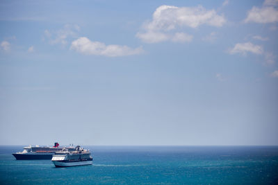 Boat sailing in sea against sky