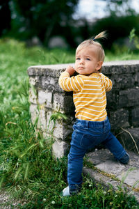 Portrait of cute baby girl on field