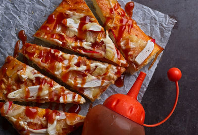 Close-up of hand holding pizza