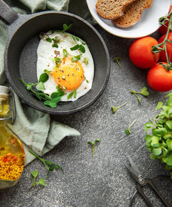 Delicious gourmet breakfast. rye bread with fried egg, freshly ground pepper and salad 