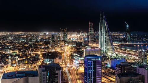 High angle view of city lit up at night