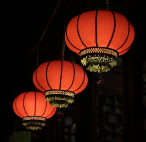 Low angle view of illuminated lanterns at night