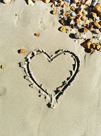 High angle view of heart shape on sand
