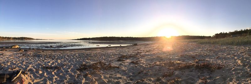 Scenic view of beach against sky during sunset