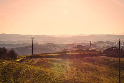 Scenic view of field against sky during sunset