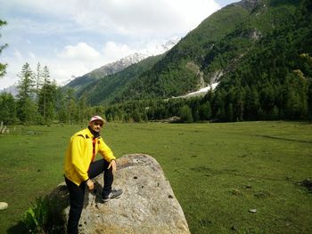 Portrait of man standing on mountain in forest