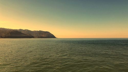 Scenic view of sea against clear sky during sunset