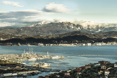 High angle view of city by sea against sky, la spezia 