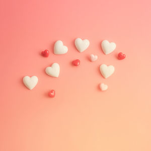 High angle view of heart shape over pink background